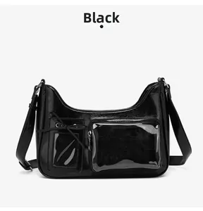 Detail of a black crossbody bag with bow decoration and transparent compartments