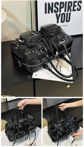 Close-up of black glossy PU leather handbag with silver metal studs and multi-zipper pockets