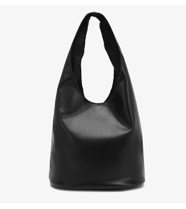 Detailed close-up of the smooth matte black leather texture on a minimalist tote bag
