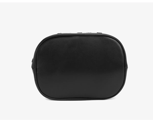 Macro detail of black leather tote bag showing smooth matte texture and rivet accents