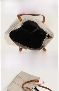 Interior macro view showing large capacity pockets and stitching on beige tote bag