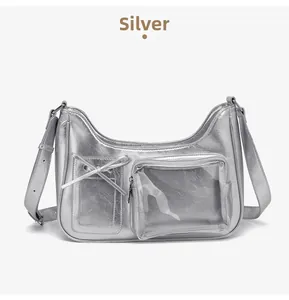 Detail of silver metallic leather crossbody bag with a bow and transparent zipper pocket