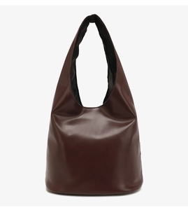 Close-up of a chocolate brown tote bag showing smooth leather texture and shoulder strap detail