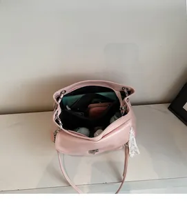 Interior view of large pink tote bag showing spacious main compartment and chain strap