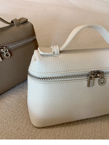 Detail von Taschen aus genarbtem Leder mit silbernen Reißverschlüssen und Griffen