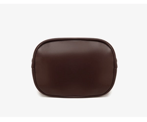 Detailed macro view of the smooth chocolate brown leather texture and stitching on the tote bag