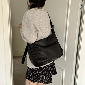 Large black matte leather hobo bag for women with wide strap and silver metal details
