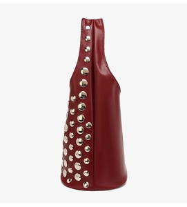 Close-up of wine red matte leather tote bag with silver hemisphere metal studs