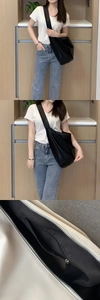 Detail view of large soft leather tote bag showing interior zipper pocket and crossbody strap
