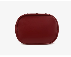 Detail view of smooth dark red leather handbag with precise stitching and metal stud accent