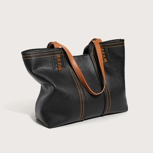 Chic black lychee grain leather tote bag with brown handles and orange stitching accents