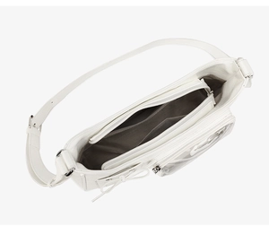 Detail view of white crossbody bag interior featuring mesh pocket and bow decoration