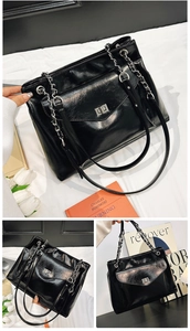 Détails du grand sac cabas en cuir brillant noir avec bandoulière chaîne et fermoir métal