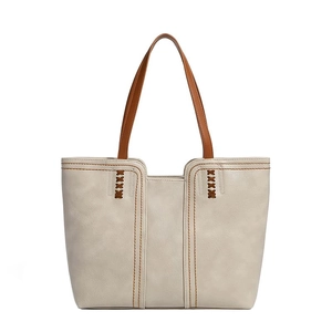 Minimalist beige oversized tote bag with brown straps and vintage stitch details