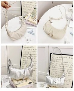 Detail showing pleated crescent hobo bag with knotted shoulder strap in ivory and silver