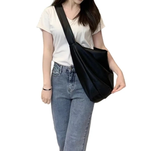 Minimalist black oversized soft leather crossbody hobo bag for women in casual street style