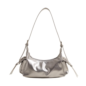 Detailed macro view of silver metallic hobo bag with reflective pleats and side ties