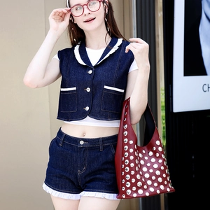 Women's burgundy studded tote bag and denim set with a stylish urban fashion aesthetic