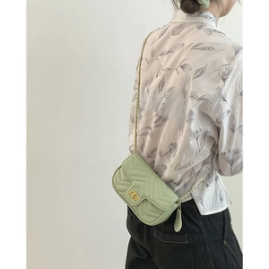 Quilted light green chain crossbody bag for women with golden twist lock and V-stitch pattern
