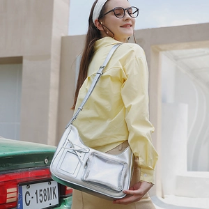 Silver metallic crossbody bag with bow detail and transparent pocket on fashion model