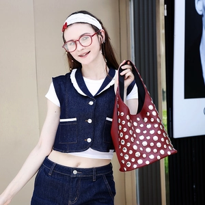 Chic rivet tote bag in dark red paired with a trendy dark blue denim outfit for women