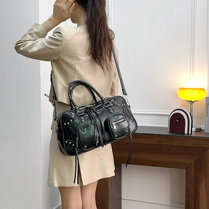 Chic black rivet tote bag with vintage texture and silver studs for women on shoulder