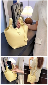 Detailansicht der gelben Leder-Eimertasche mit Narbenmuster und Innenraum-Anzeige