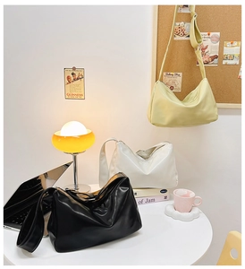 Detailed view of glossy PU leather hobo bags in black, white and lime green colors