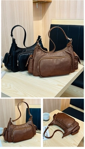 Detail view of large Hobo shoulder bag showing leather texture and multi-pocket design