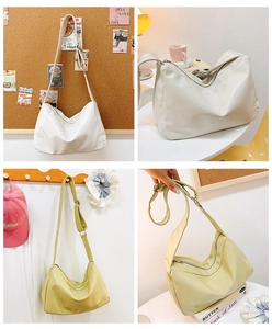 Detail view of large tote bags in cream and yellow with adjustable wide shoulder straps
