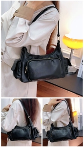 Detail of vintage black crossbody bag with multiple pockets and polished leather texture