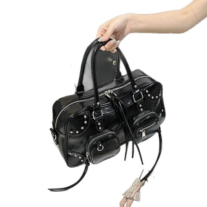 Fashionable black faux leather tote bag with silver studs and tassel zippers