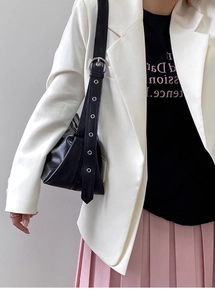 Detail of adjustable wide shoulder strap with silver metal eyelets on black hobo bag