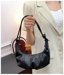 Close-up of black crescent hobo bag with soft pleated leather and Fashion logo detail