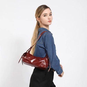 Retro wine red soft leather shoulder bag for women with glossy finish and sleek side ties