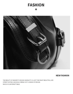 Detailed macro view of black textured leather bag with silver metal ring and hardware