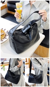 Close-up of a large black glossy faux leather hobo shoulder bag for daily commuting