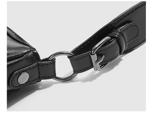 Detail of matte black leather bag featuring gunmetal hardware and precise stitching