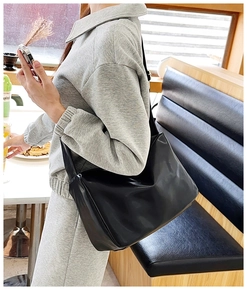 Close-up of black tote bag in soft PU leather showing spacious interior and sleek texture