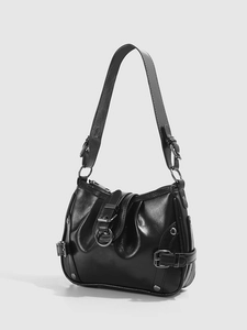 Detail of black motorcycle shoulder bag with metallic buckles and rivets in half-moon shape