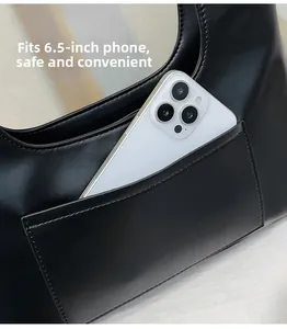 Detail showing side pocket of black faux leather bag fitting a 6.5-inch smartphone