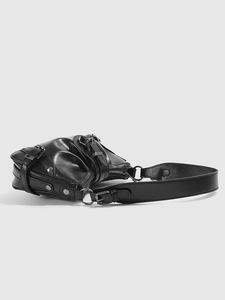 Detail of black motor-style shoulder bag with silver metallic buckles and rivets