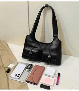 Detail of black motorcycle shoulder bag showing large capacity with daily essentials items