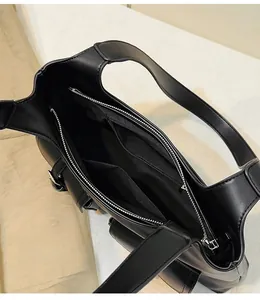 Detailed view of internal compartments and zipper pockets in black motorcycle tote bag