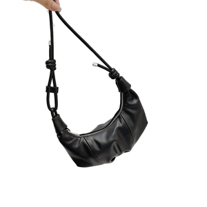Minimalist black croissant crossbody bag with knotted strap and fashion logo text