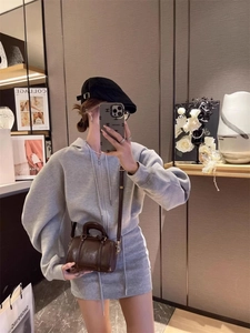 Mini brown leather Boston bag styled with a grey knitted hoodie and skirt set