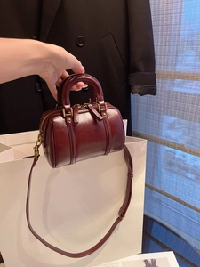 Deep red oily leather Boston bag with vintage gold zippers and adjustable shoulder strap
