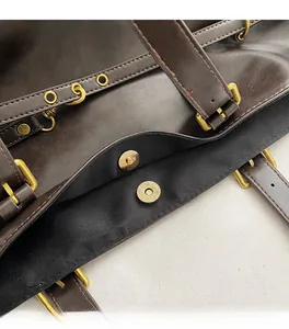 Detail of vintage brown PU leather tote bag showing the magnetic buckle closure mechanism