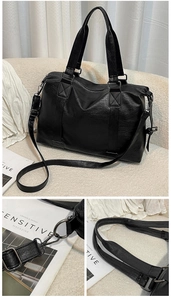 Macro view of gunmetal-tone hooks and adjustable shoulder strap on black travel bag