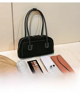 Detail showing internal capacity of black suede tote with stitching for daily essentials